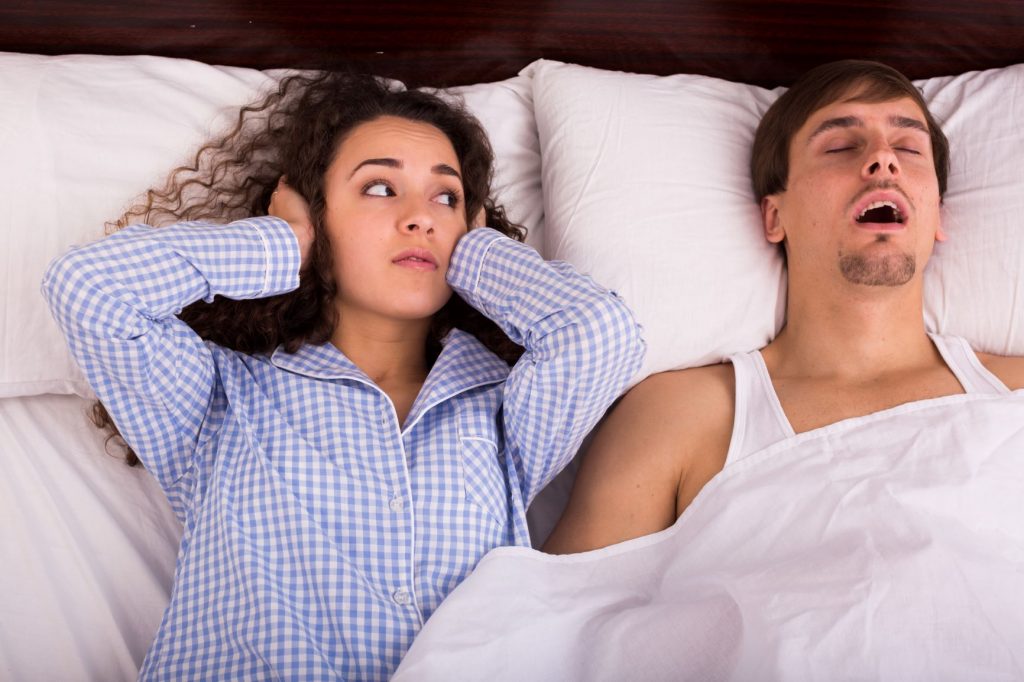 Man Snoring and Keeping woman awake