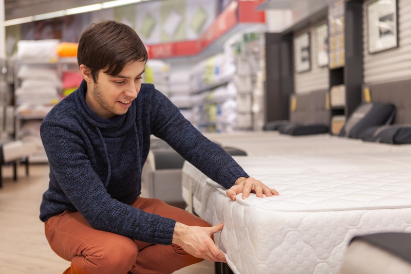 man buying a new mattress 